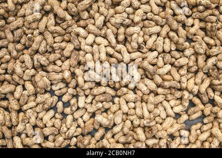 Peanuts in shell texture background. Raw peanuts on display at a farmer's market. Close up image. Stock Photo