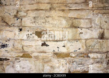 Mixed brown, grey and white brick wall background texture with abstract stone patterns and shapes. Stock Photo