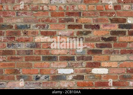 Weathered brick wall texture background showing vintage bricks, mortar and abstract patterns. Stock Photo