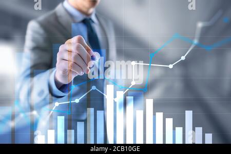 Businessman drawing graph with marker on media screen. Stock Photo