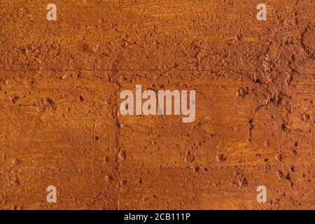 Traditional moroccan terracotta colored background. Orange or ocher clay wall texture. Painted shabby concrete. Stock Photo