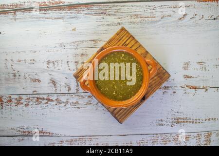 top view of mexican green sauce in clay pot Stock Photo