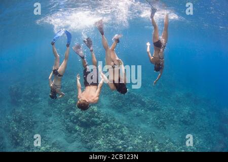 A group (MR) free diving down to a Hawaiian reef. Stock Photo