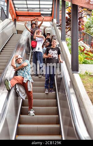 Medellin / Colombia - July 15, 2017: group of young hiphop dancer going up escalator in Comuna 13 Stock Photo