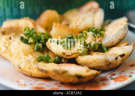 Vietnamese street food 'banh can' make by rice powder with rice flour, egg, onion leaves. Banh can is a portion of Vietnamese street food. Food photog Stock Photo