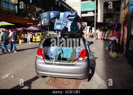 Medellin / Colombia - July 15, 2017: mobile stall selling clothes in the trunk of a car Stock Photo