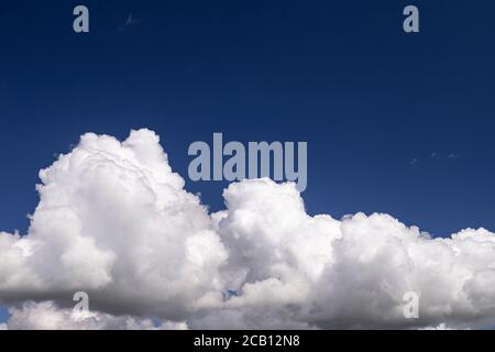 Large cumulus cloud in a deep blue sky Stock Photo