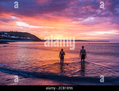Myrtleville, Cork, Ireland. 10th August, 2020. On a glorious summer's morning, Grace and Liam Meade from Crosshaven go for their daily dawn swim at Myrtleville, Co. Cork, Ireland. - Credit; David Creedon / Alamy Live News Stock Photo