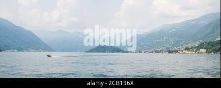 Picturesque Landscape on Lake Como with Alps on Background. Italy. Panoramic View. A Magical Panoramic Landscape. Stock Photo