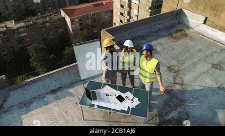 Team of architects people in group on construciton site check documents and business workflow. Stock Photo