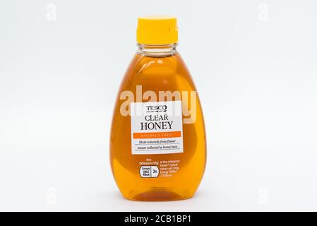 Irvine, Scotland, UK - August 08, 2020: Tesco Branded Plastic Bottle of Clear Honey in recyclable plastic bottle and cap. Bootle also contains energy Stock Photo
