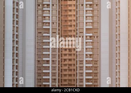 Mumbai, Maharashtra, India - March 2020: Modern symmetry of the geometric exterior facade of a highrise residential apartment building. Stock Photo