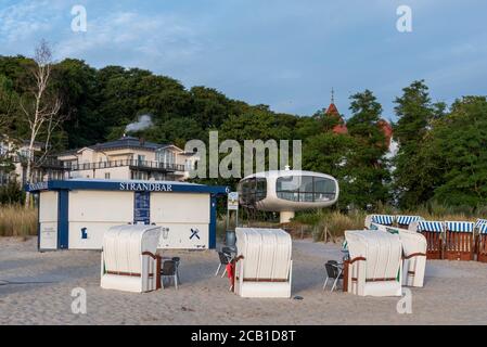 Binz, Germany. 05th Aug, 2020. The Müther tower is located behind beach chairs. The futuristic building was erected in 1981 as a rescue tower at a Baltic Sea entrance. It was built by the shell concrete master builder Ulrich Müther. Today the tower serves as a wedding room for weddings. Credit: Stephan Schulz/dpa-Zentralbild/ZB/dpa/Alamy Live News Stock Photo