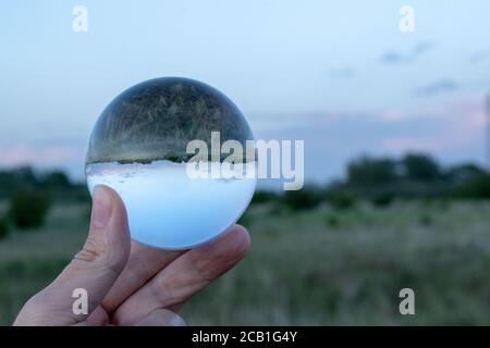 Beautiful shot of man's hand holding a crystal ball Stock Photo
