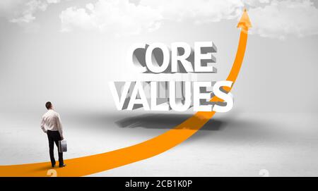 Rear view of a businessman standing in front of CORE VALUES inscription, successful business concept Stock Photo