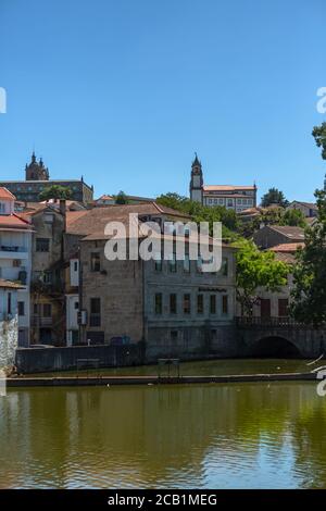 Viseu / Portugal - 07/31/2020 : View at the Viseu city downtown, with the Paiva river , classic buildings and Cathedral of Viseu and Church of Mercy o