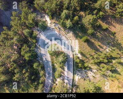 Aerial drone view of U Turn Road Curve in forest . Stock Photo