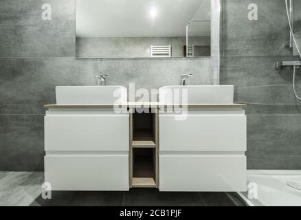 Contemporary White And Gray Bathroom With Oversized Double Sink Large Mirror And Spacious Shower. Stock Photo