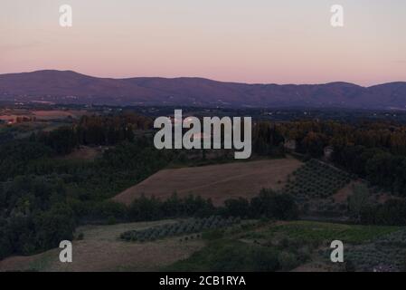 Evening lights on the Tuscan landscape, view from the town of San Gimignano