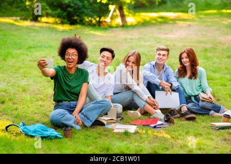 Happy Multicultural College Students Having Fun While Taking Group Selfie Outdoors Stock Photo