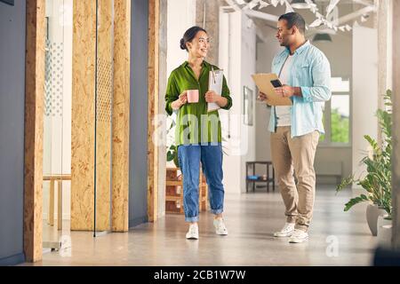 Two international young people having pleasant communication Stock Photo