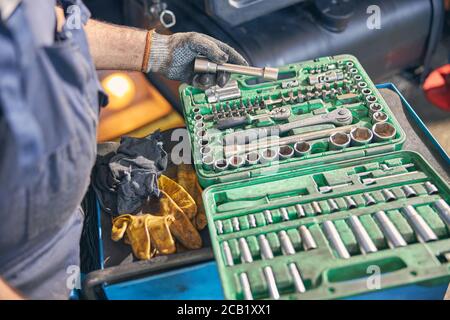 Focused photo on male hand taking spanner Stock Photo