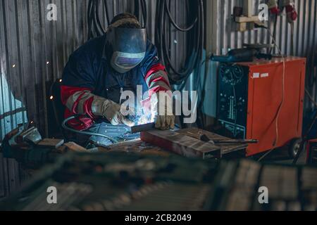 Concentrated welder using mask while doing serious work Stock Photo