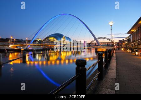The Millennium and Tyne Bridges spanning the River Tyne between Newcastle and Gateshead in Tyne and Wear, North-East England. Taken at dusk during the Stock Photo