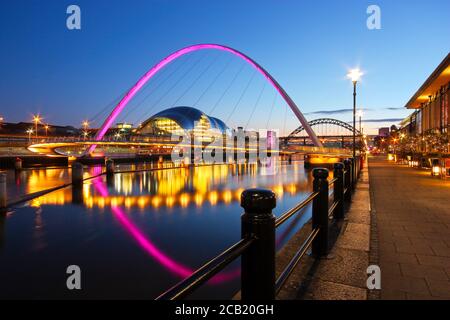 The Millennium and Tyne Bridges spanning the River Tyne between Newcastle and Gateshead in Tyne and Wear, North-East England. Taken at dusk during the Stock Photo