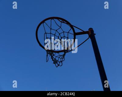 Basket ball net on stand against deep blue sky with copyspace Stock Photo