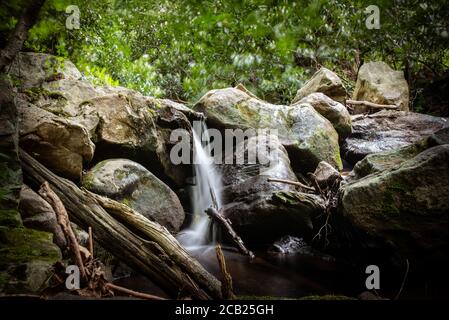 Small natural waterfall along a wild mountain stream Stock Photo