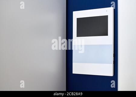 Video intercom on wall. Video door phone. Modern minimalistic sensor panel. Security safety system in rent apartment. Access permission system Stock Photo