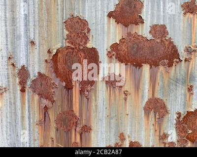 faded eroded close-up rusted sheet metal siding steal wall suitable for website marketing background backdrop setting architecture architectural layou Stock Photo