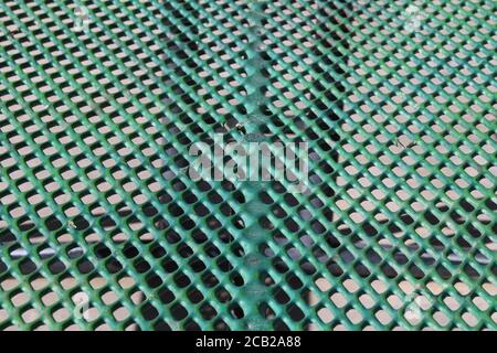 green close-up angle outdoors metal perforated picnic table suitable for website marketing background backdrop setting architecture architectural layo Stock Photo