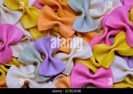 Colorful Italian raw pasta Farfalle Uncooked pasta as background Stock Photo