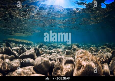 Underwater view with stones and blue transparent sea water. Stock Photo