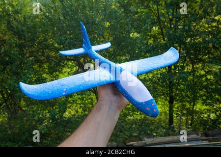 toy foam airplane in hands Stock Photo