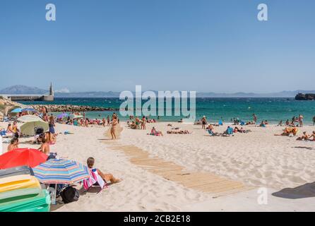 Tarifa Beach, High season with sunbathers at Atlantic ocean, Playa chica, during Covid 19 crisis, Tarifa,, Andalusia, Spain Stock Photo