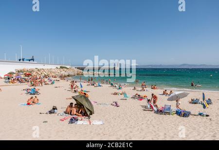 Tarifa Beach, High season with sunbathers at Atlantic ocean, Playa chica, during Covid 19 crisis, Tarifa,, Andalusia, Spain Stock Photo