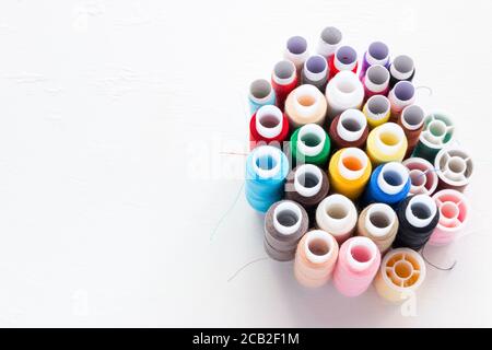 multicolored thread on white background with place for text Stock Photo