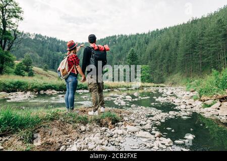 Young couple exploring nature by the mountain river Stock Photo