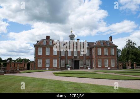 Hanbury Hall on 10th July 2020 in Hanbury, United Kingdom. Hanbury Hall is a large 18th-century stately home standing in parkland at Hanbury, Worcestershire. The main range has two storeys and is built of red brick in the Queen Anne style. It is a Grade I listed building, and the associated Orangery and Long Gallery pavilion ranges are listed Grade II. It is managed by the National Trust and is open to the public. Stock Photo