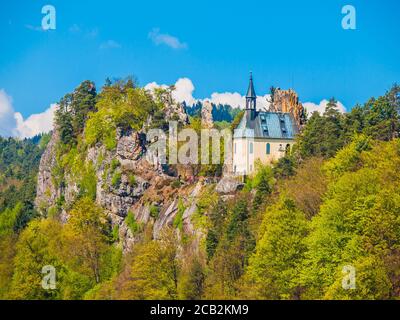 Ruins of Vranov Castle with small rock chapel, Pantheon, in Mala Skala on sunny summer day with blue sky and lush green trees, Bohemian Paradise, aka Cesky Raj, Czech Republic, Europe. Stock Photo