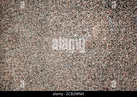 Granular roofing surface close-up, small red-brown stones, stone crumb Stock Photo