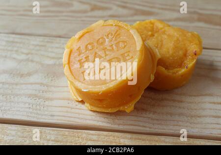 Two blocks of home made soap on a wooden background. Hand made soap with natural ingredients concept, high angle view. Copyspace to left. Stock Photo