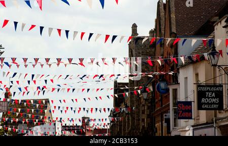 Bunting flying above a street in the cathedral city of Ely, Cambridgeshire, England. Stock Photo