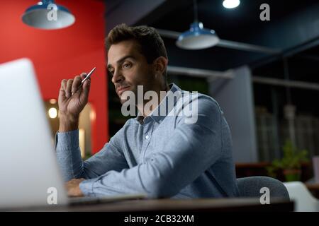 Focused young businessman working at his desk after hours Stock Photo