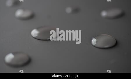 Water droplets on flat grey surface Stock Photo