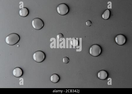 Water droplets on flat grey surface Stock Photo