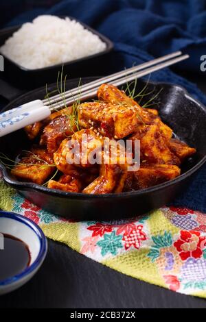 Healthy Asian food concept Homemade stirs fried spicy chili sauce, organic tofu in skillet iron pan with copy space Stock Photo